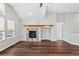 Bright living room featuring fireplace, large windows, vaulted ceilings, and hardwood floors at 7560 S Biloxi Ct, Aurora, CO 80016