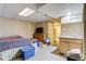 Basement features a bed, TV, and kitchenette area for added living space at 2035 Overland Dr, Brighton, CO 80601