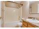 Cozy bathroom featuring a shower-tub combo, toilet, and single sink vanity with wood-look cabinetry at 2035 Overland Dr, Brighton, CO 80601
