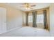 Bright bedroom with a ceiling fan, natural light, and patterned curtains framing the windows at 2035 Overland Dr, Brighton, CO 80601