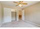 Bedroom with closet, ceiling fan, and open doorway leading to the hallway at 2035 Overland Dr, Brighton, CO 80601