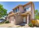 Brick facade townhome with attached garage and covered front porch at 2035 Overland Dr, Brighton, CO 80601