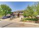 Exterior view of well-maintained townhomes with driveways and mature trees at 2035 Overland Dr, Brighton, CO 80601