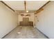 Organized garage with storage cabinets, shelving, and concrete flooring at 2035 Overland Dr, Brighton, CO 80601