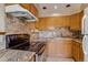 Well-lit kitchen with tile backsplash, ample cabinet space, and modern appliances at 2035 Overland Dr, Brighton, CO 80601