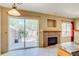 Cozy fireplace, sliding glass doors, and backyard access at 2035 Overland Dr, Brighton, CO 80601