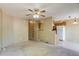 Open-concept living space with neutral walls connecting to the kitchen at 2035 Overland Dr, Brighton, CO 80601