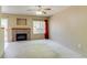 Bright living room featuring a cozy fireplace, neutral carpet, and natural light at 2035 Overland Dr, Brighton, CO 80601