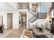 An open concept living area with stairs and wood floors. Decorated with stylish furniture at 4284 Ridgewalk Pt, Castle Rock, CO 80108
