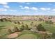 Breathtaking aerial view of the golf course, showcasing its green fairways, mature trees, and surrounding community at 11 Canongate Ln, Highlands Ranch, CO 80130