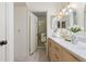 Bathroom with a marble countertop, double vanity, and glass-enclosed shower, seamlessly blending style with functionality at 11 Canongate Ln, Highlands Ranch, CO 80130