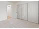Neutral bedroom featuring lots of closet space, neutral carpet and a door to the hallway at 11 Canongate Ln, Highlands Ranch, CO 80130