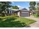 Charming single-Gathering home featuring a well-manicured lawn, mature trees, and an attached two-car garage at 11 Canongate Ln, Highlands Ranch, CO 80130