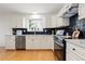 Well-lit kitchen featuring white cabinets, granite countertops, and stainless steel appliances at 11 Canongate Ln, Highlands Ranch, CO 80130