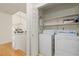 Functional laundry room with modern appliances, built-in shelving, and ample storage space, making chores a breeze at 11 Canongate Ln, Highlands Ranch, CO 80130