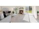 Bright living room with a brick fireplace, slider to deck, and modern decor at 11 Canongate Ln, Highlands Ranch, CO 80130