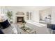 Bright living room with a fireplace and open access to other rooms at 11 Canongate Ln, Highlands Ranch, CO 80130