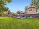 Spacious backyard with a pergola-covered patio, lush green lawn, and a privacy fence, perfect for relaxing outdoors at 6664 Gray St, Arvada, CO 80003