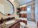 Bathroom features granite countertops, a large mirror, and a shower-tub combination at 6664 Gray St, Arvada, CO 80003