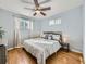 Bright bedroom with hardwood floors, ceiling fan, and plenty of natural light at 6664 Gray St, Arvada, CO 80003
