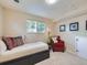 Cozy bedroom featuring a twin bed, chair, and soft, neutral carpeting, perfect for relaxation and comfort at 6664 Gray St, Arvada, CO 80003