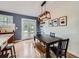 Dining room features modern light fixture, and a glass door to the backyard at 6664 Gray St, Arvada, CO 80003