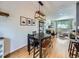 Dining room features modern light fixture and flows into the living room at 6664 Gray St, Arvada, CO 80003