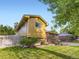 View of the home's exterior and manicured lawn, showcasing its curb appeal and well-maintained surroundings at 6664 Gray St, Arvada, CO 80003