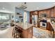 Spacious kitchen featuring a center island, stainless steel appliances, granite countertops, and ample storage at 6664 Gray St, Arvada, CO 80003