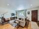 Cozy living room featuring hardwood floors, stylish furniture, and a welcoming atmosphere for comfortable living at 6664 Gray St, Arvada, CO 80003