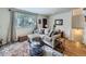Bright living room showcasing hardwood floors, a comfortable sofa, and a large window with natural light at 6664 Gray St, Arvada, CO 80003