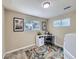 Bright home office with multiple windows, a workspace, and a colorful area rug at 6664 Gray St, Arvada, CO 80003