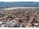 Sweeping aerial view of a residential area near a lake, backed by distant mountains and with a city skyline on the left at 2351 Federal Blvd # 102, Denver, CO 80211