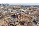 Aerial view of a multi-story brick building with parking, surrounded by urban landscape and the city skyline at 2351 Federal Blvd # 102, Denver, CO 80211