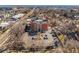Aerial view of the exterior of a commercial brick building with a parking lot, located near a busy street at 2351 Federal Blvd # 102, Denver, CO 80211