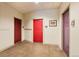 Hallway view featuring carpet flooring and colorful doors with unit numbers at 2351 Federal Blvd # 102, Denver, CO 80211