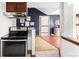 Efficient kitchen with stainless steel appliances, bar seating, and seamless flow to other rooms at 2351 Federal Blvd # 102, Denver, CO 80211
