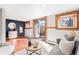 Bright living room with terra cotta floors, natural wood trim, neutral decor, and an exterior door at 2351 Federal Blvd # 102, Denver, CO 80211