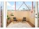 Private patio area features outdoor furniture, light-colored fencing, and a geometric rug at 2351 Federal Blvd # 102, Denver, CO 80211