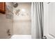 Tiled shower with modern fixtures and a stylish shower curtain in a well-lit bathroom at 2351 Federal Blvd # 102, Denver, CO 80211