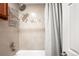 A clean shower featuring neutral tile and a mosaic accent at 2351 Federal Blvd # 102, Denver, CO 80211