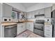 Well-lit kitchen featuring stainless steel appliances, light gray cabinetry, and butcher block countertops at 4726 S Taft St, Morrison, CO 80465