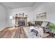 Bright living room with a stone fireplace, hard wood floors, and comfortable seating at 4726 S Taft St, Morrison, CO 80465