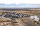 A Primary-planned community shown via aerial view, featuring new construction and open spaces at 2405 Horse Shoe Cir, Fort Lupton, CO 80621