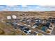 Aerial view of a well-planned community with modern homes and developing land at 2405 Horse Shoe Cir, Fort Lupton, CO 80621