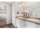 Bathroom featuring double sinks, a large mirror, and a walk-in shower at 2405 Horse Shoe Cir, Fort Lupton, CO 80621