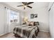 Cozy bedroom with football-themed decorations and a large window providing natural light at 2405 Horse Shoe Cir, Fort Lupton, CO 80621