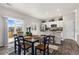 Bright dining area with a modern table, chairs, and a view of the kitchen at 2405 Horse Shoe Cir, Fort Lupton, CO 80621
