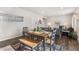 Open dining area with a wooden table, chairs, bench, and natural light at 2405 Horse Shoe Cir, Fort Lupton, CO 80621