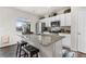 Bright kitchen with stainless steel appliances, granite countertops, and a central island with bar seating at 2405 Horse Shoe Cir, Fort Lupton, CO 80621